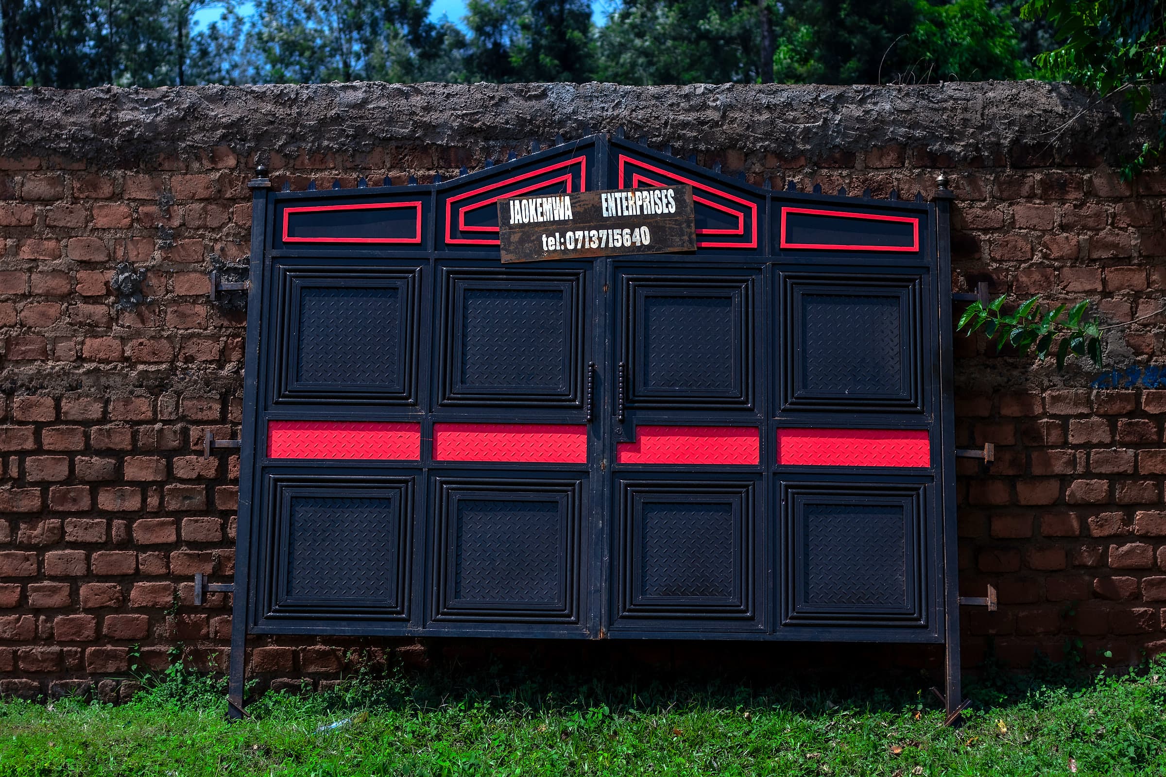Black & Red Panel Gate on Brick Wall